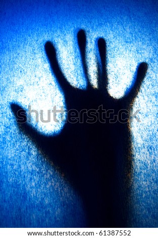 silhouette of hand on blue background