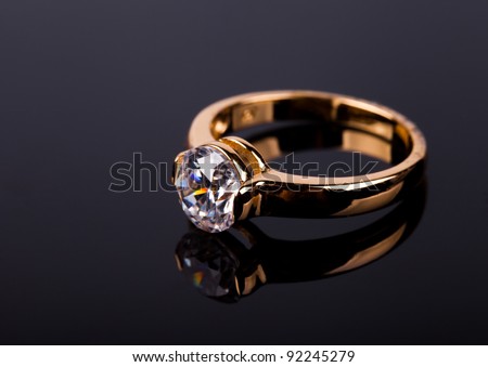 stock photo wedding ring with stone on black background