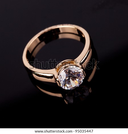 stock photo wedding ring with stone on black background