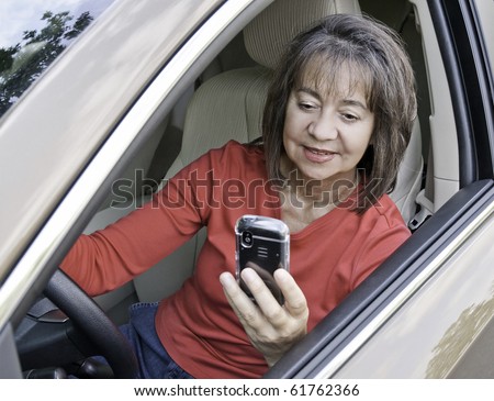 A woman driver distracted by  a cell phone