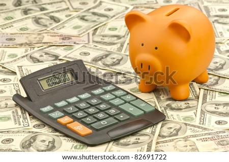 Piggy bank and calculator  with a large sum of money