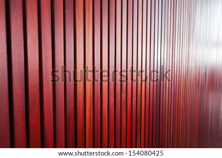 A shallow focus background of some brown wooden panels on the interior wall of a building.  Focus just to the left of centre.