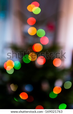 An abstract shot of multi-coloured Christmas tree lights causing a bokeh effect.