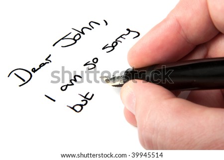 A male hand writing a \