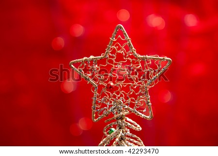 A gold star on a red background with some highlights in the background.