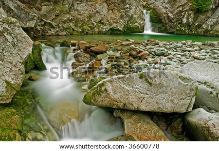 Low Waters - little river flowing among the rocks underneath a waterfall