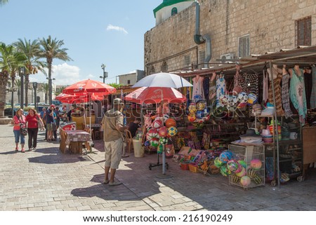 Acre, Israel - September 9, 2014: Tourists and shoppers walking by Acre\'s old city street market, known as the Grand bazaar and  for it\'s unique stores and middle eastern food.
