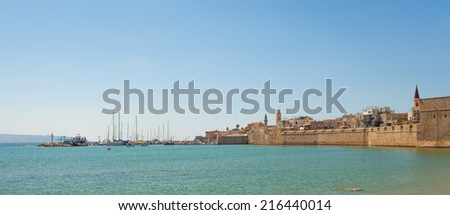 Port of Acre, Israel. with boats and the old city in the background.