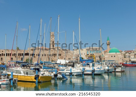 Acre, Israel - September 9, 2014:  Port of Acre, Israel. with boats mosque and the old city in the background.