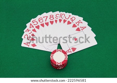 Cards and casino chips on green casino table
