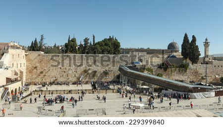 Jerusalem, Israel - November 9, 2014 : Local People and tourists pray at the western wall. The western wall is an exposed section of ancient wall situated on the western flank of the Temple Mount.