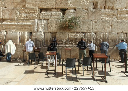Jerusalem, Israel - November 9, 2014 : Jewish orthodox men pray at the western wall. The western wall is an exposed section of ancient wall situated on the western flank of the Temple Mount.