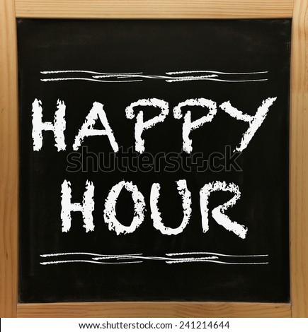 Happy hour sign on chalkboard