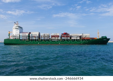 Haifa, Israel - January 23, 2015: Medium sized container ship leaving the port of Haifa, fully loaded.Haifa\'s port is located in a natural, protected bay in the north of Israel.