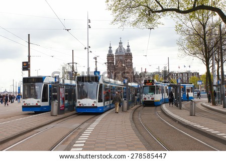 Amsterdam, The Netherlands - May 1, 2015: Tram (Local light rail transportation) heading to Amsterdam central station.