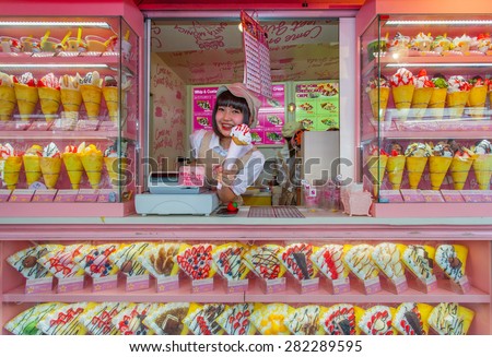 Tokyo, Japan - May 14, 2015: Crape and ice cream vendor at Harajuku's Takeshita street, known for it's Colorful shops and Punk Manga - Anime overall look.