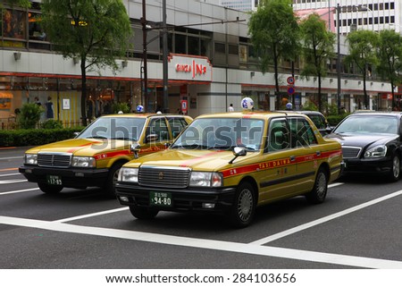 Tokyo,Japan - May 12, 2015: Typical local Japanese Taxis standing in traffic at Tokyo\'s high end Ginza district.