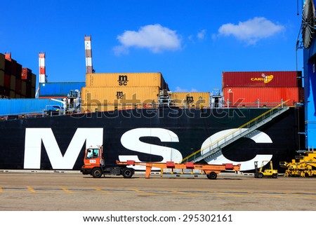 Haifa, Israel - July 10, 2015: Haifa\'s Port dock with container ship and Various brands and colors of shipping containers stacked onboard