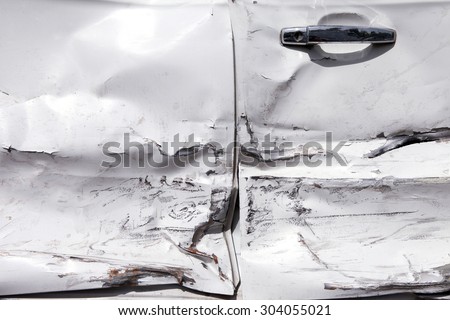 White car door with damage due to accident