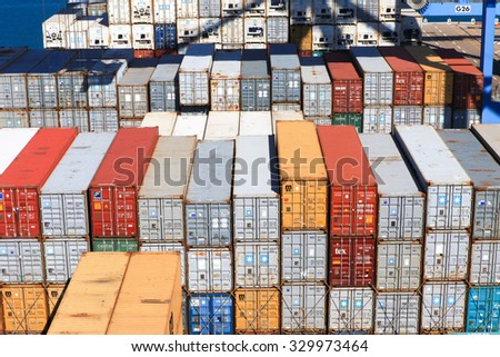 Haifa, Israel - October 15, 2015 : Various brands and colors of shipping containers stacked on a mega container ship