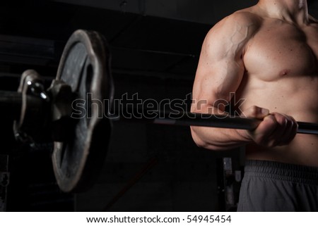 Torso of a shirtless guy lifting weights