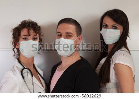 Group of three young people wearing surgical masks