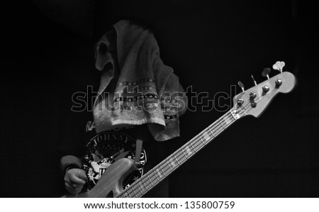 The bass player dry his sweat after the performance