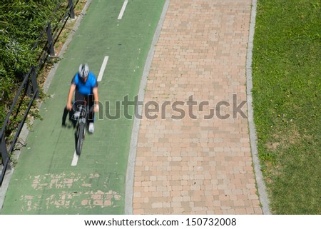 Man biking in motion, Man with helmet on bike on the park, Salamanca, Spain