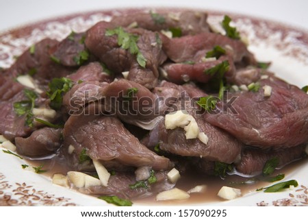 Marinated pork cheeks (non cooked) with wine, parsley and wine