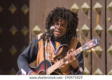 GRANADA, SPAIN, MARCH 7: Black rasta street musician man playing at Granada downtown, Spain on 7 March 2009