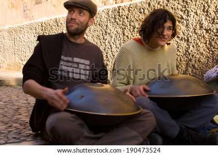 GRANADA, SPAIN, MARCH 7: Unknown street artists playing a swiss instrument called Hang Granada Street, Spain on 7 March 2009