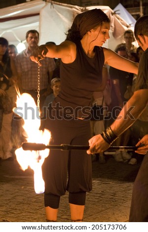 BADAJOZ, SPAIN - SEPTEMBER 26: Street performers holds lighted torchs during the Almossasa Culture Festival on September 26, 2009 in Badajoz, Spain