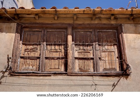 Old wooden window with rain gutter and clothes dryer