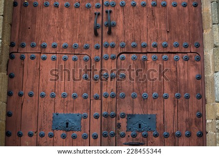 Beautiful old wooden door with iron ornaments at medieval city of Caceres, Spain