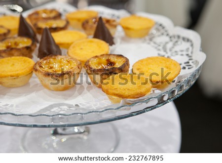 Portuguese egg custard pastry also named Pasteis de nata over glass stand