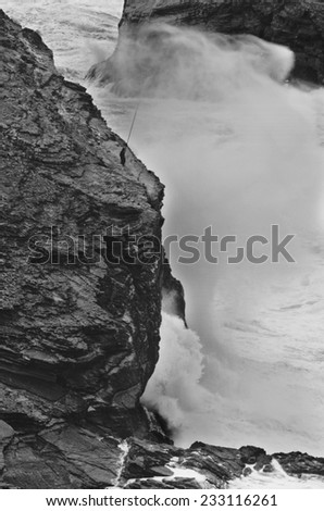 ALGARVE, PORTUGAL - JANUARY 24: Severe dramatic seascape with fisherman in Cape Saint Vicent cliffs on the Atlantic coast on January 24, 2009, Portugal