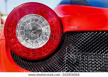 BADAJOZ, SPAIN - MARCH 14, 2015: Ferrari Car show at Badajoz City on Complejo Alcantara resorts, March 14, 2015. Red sports car spot light. Detail of a luxury car