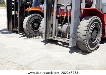 Parts of forklift loader for warehouse works outdoors. Forklift loaders tires