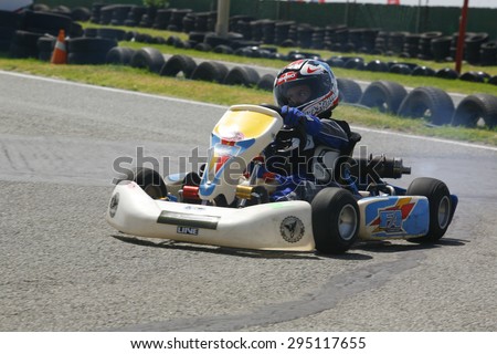 MARBELLA - JUL 8: unidentified kid driving competition kart on training at Funny Beach circuit on Jule 8, 2015 in Marbella, Spain