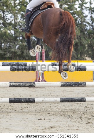 Detailed view of the horseshoes while the animal is jumping at competition
