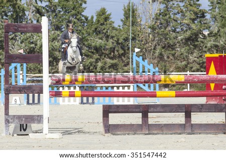 BADAJOZ, SPAIN - Nov 22: Horse starting to jump several obstacles close by at Poni Club Local Cup Qualifying competition on November 22, 2015 in Spain