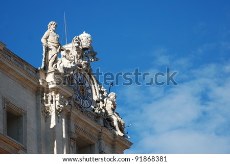 view of the clock statue in the top corner of the St. Peter\'s basilica in Rome, italy