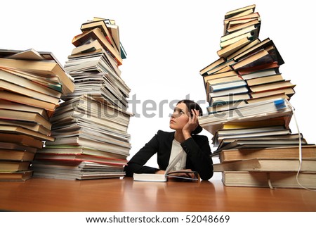 girl reading a book (many books on the table)