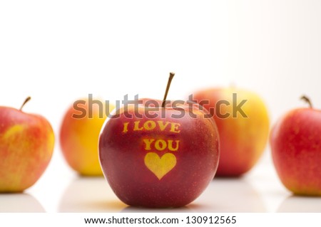 apple with the words  I LOVE YOU arranged in a row