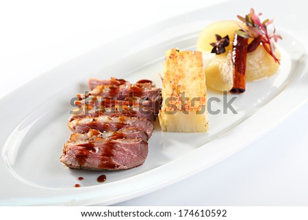 a decorated dish of meat and potatoes