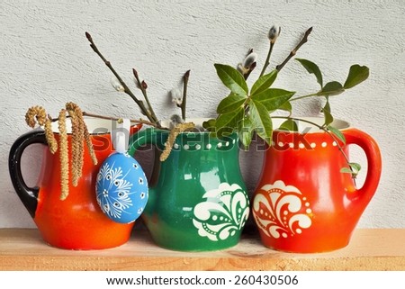 Easter decoration with variegated mugs,egg and catkins