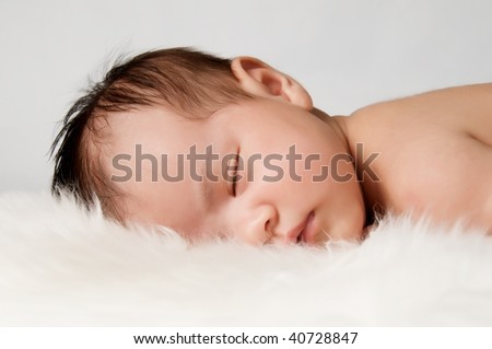 Baby lying on a fur blanket