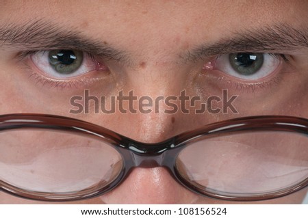 young man eyes and old glasses