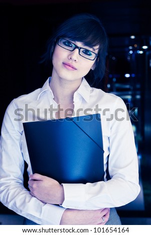Futuristic portrait of a young beautiful asian woman in a business suit holding a folder.