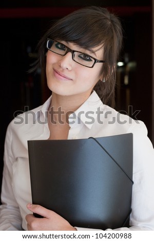 Smart looking asian woman holding a folder